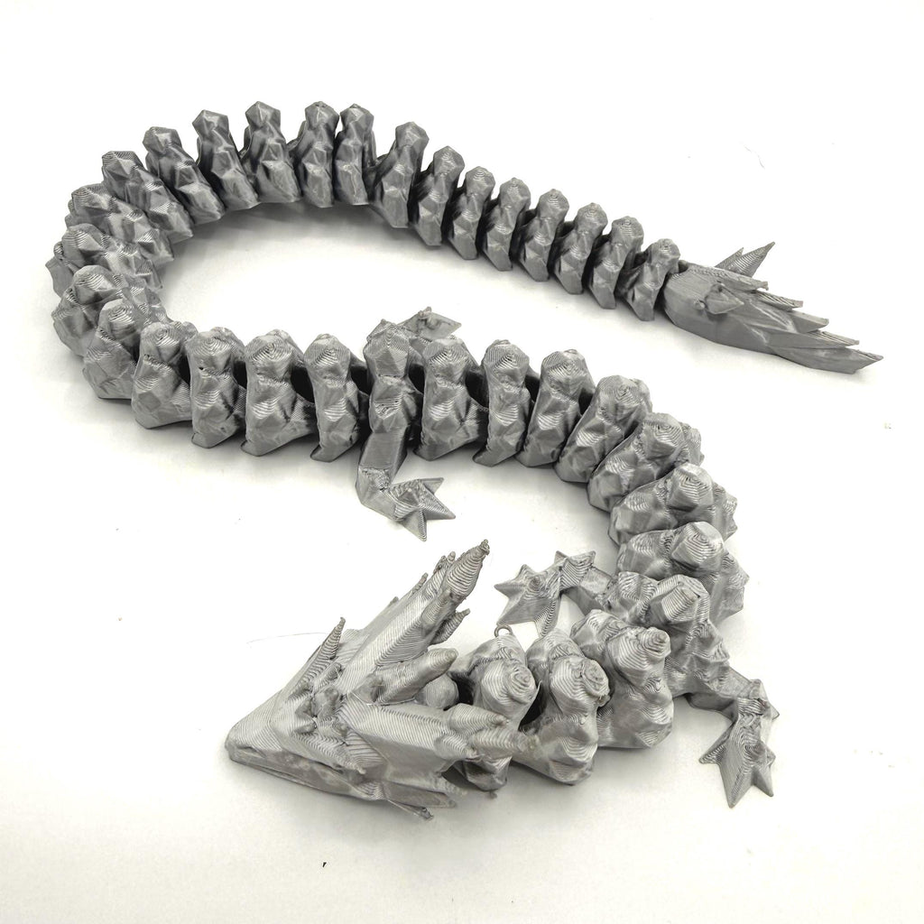 A silver 3D-printed articulated fantasy creature or dragon-like monster, shown coiled on a plain white background.
