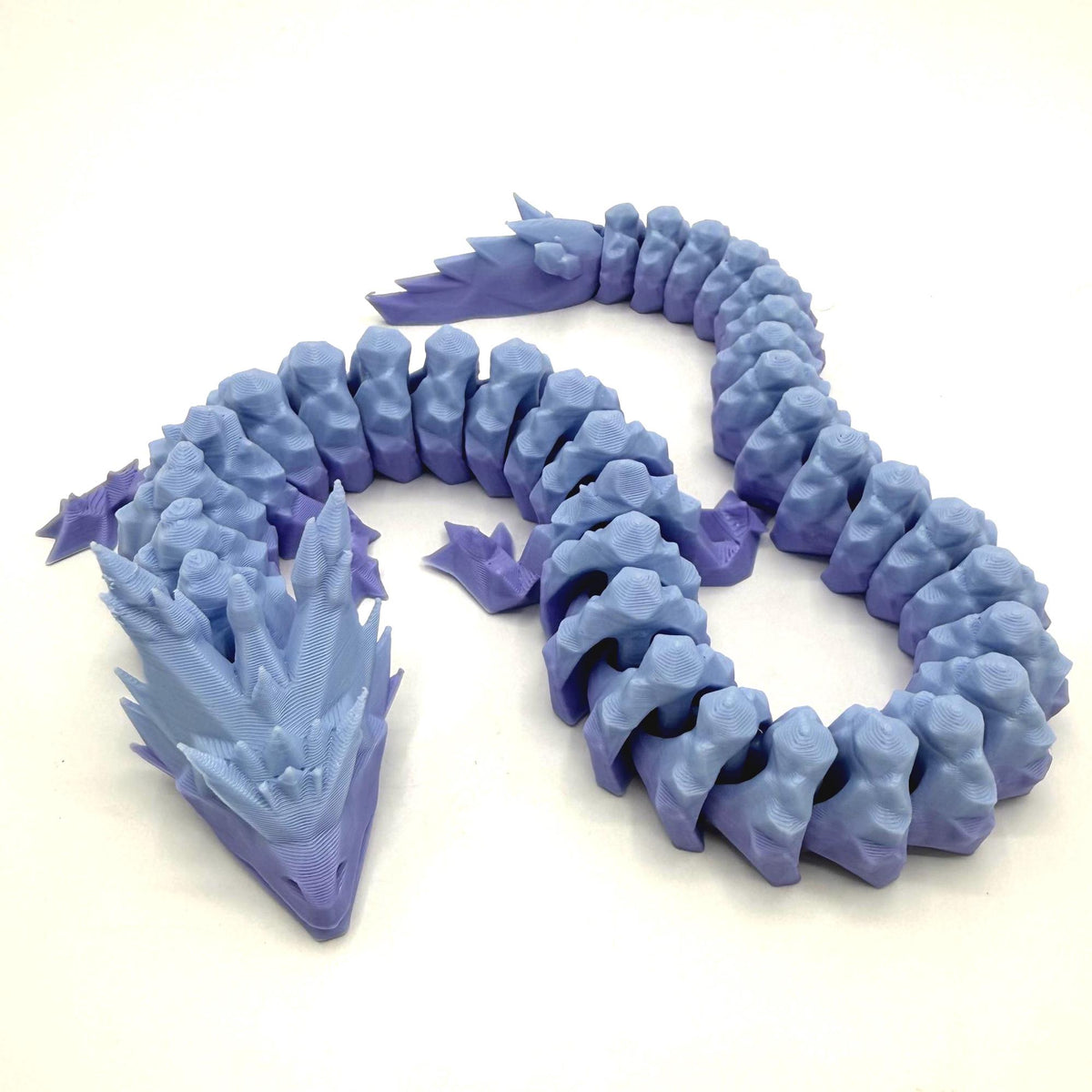 A 3D-printed articulated snake toy in shades of periwinkle and lavender, displayed on a clean white background.
