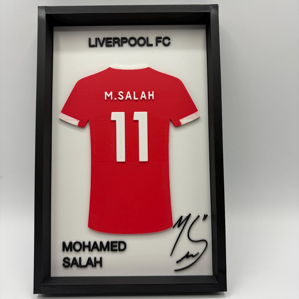 A framed custom red Liverpool FC Mohamed Salah jersey display. The black shadowbox frame features a red jersey with 'M.