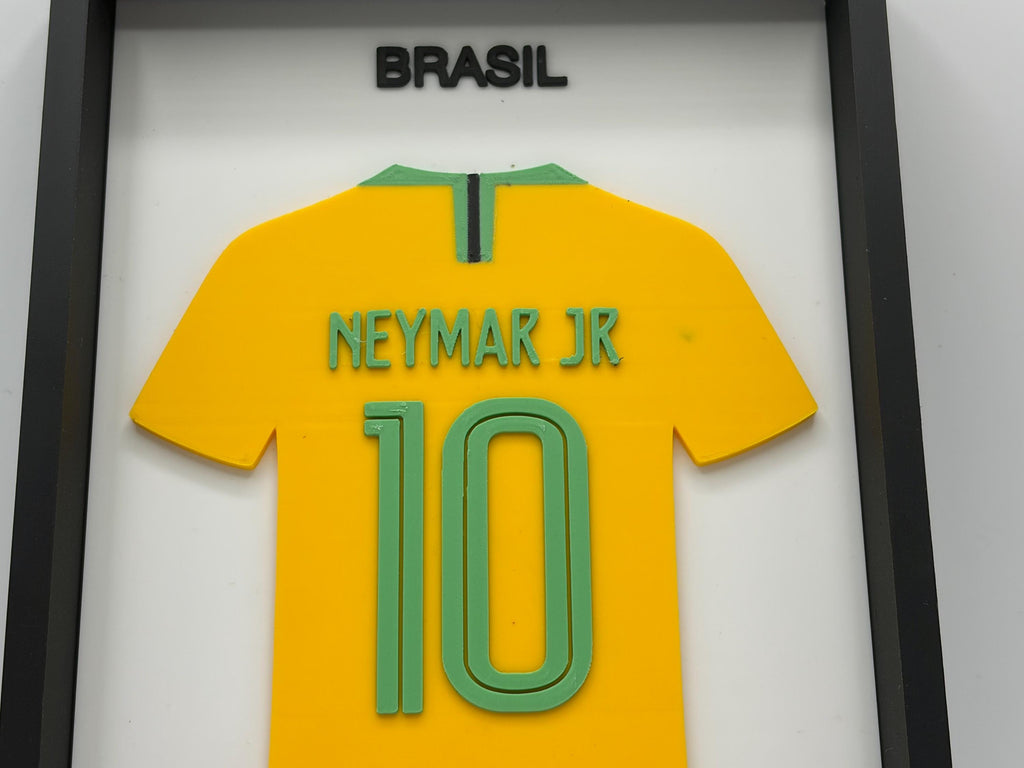 A framed yellow Brazil soccer jersey with green trim, featuring the name 'NEYMAR JR' and number '10' on the back, with 'BRASIL' displayed above, set in a black frame.