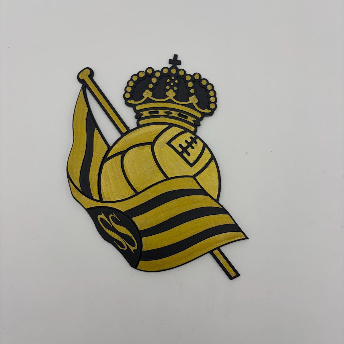 A yellow and black embroidered patch featuring a crown, a soccer ball, and a striped flag with the letters 'S' and 'C', shown on a plain white background.